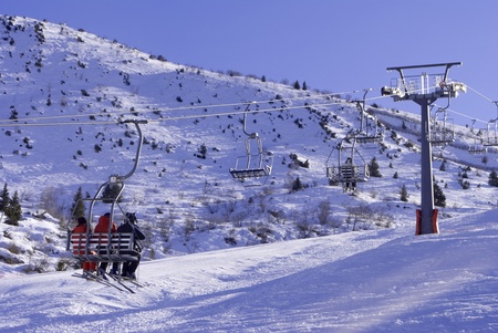 Ski lift chairs on bright winter day in Trentino, Italy