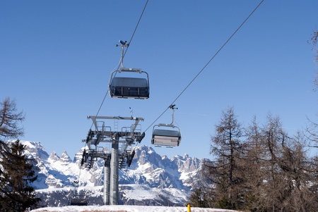 Ski lift chairs on bright winter day in Trentino, Italy