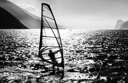 Surfing in the evening on the Garda lake,Torbole, Italy の写真素材