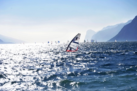 Surfing in the evening on the Garda lake,Torbole, Italy の写真素材