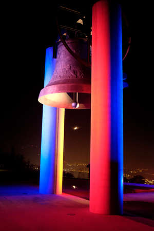 ROVERETO, ITALY - NOVEMBER 16, 2015: The great Peace Bell Dolens Mary  lit up with the Tricolor in a show of support for the people of France following the deadly terrorist attacks in Paris.のeditorial素材