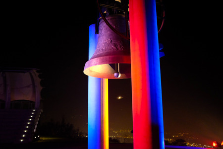 ROVERETO, ITALY - NOVEMBER 16, 2015: The great Peace Bell Dolens Mary  lit up with the Tricolor in a show of support for the people of France following the deadly terrorist attacks in Paris.のeditorial素材
