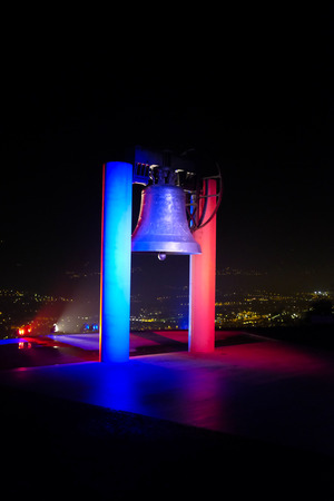 ROVERETO, ITALY - NOVEMBER 16, 2015: The great Peace Bell Dolens Mary  lit up with the Tricolor in a show of support for the people of France following the deadly terrorist attacks in Paris.のeditorial素材