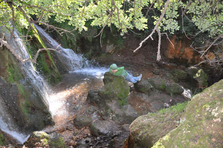 hiker resting at farod waterfallの写真素材