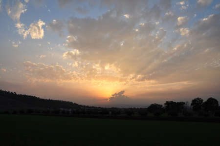 The sun goes down on  urban and country side landspace, north israel.の写真素材