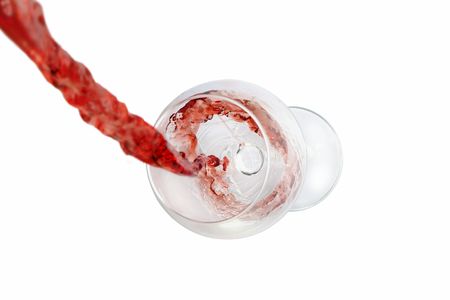 Filling of a wine glass with red wine. The focus is on the wine in the glass.の写真素材