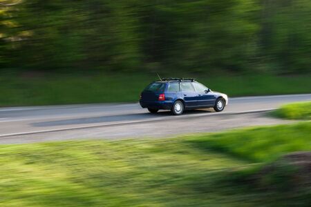 Car driving through a forrestの写真素材