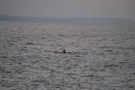 Boat in the sea drives towards the pier