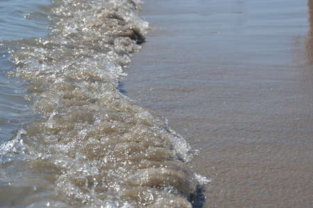 Sandy beach with ocean waves in porto portugal