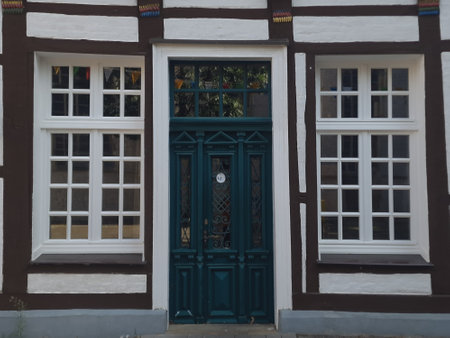 Rectangular windows with square divisions and white frames on a half-timbered houseの写真素材