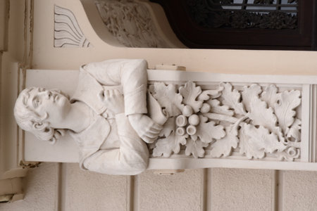 A beautiful Art Nouveau facade sculpture of a young woman. The detailed figure, with long hair...