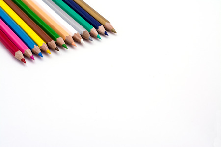 Colored pencils in a line on a white backgound の写真素材