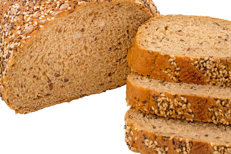isolated wholemeal bread slice with poppy, sunflower, and sesame seeds on a bread broad