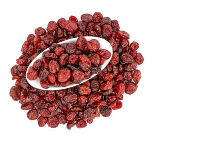 Dried Cranberries some in a white dish isolated on a white backgroundの写真素材