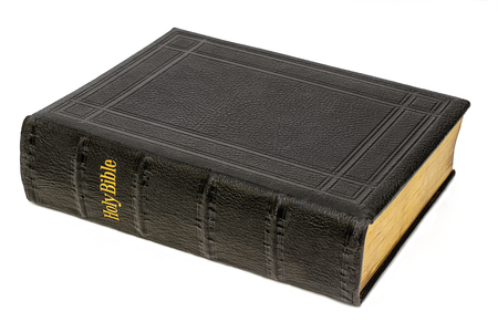 Large antique holy bible, black leather with gold writing, whith background,の写真素材