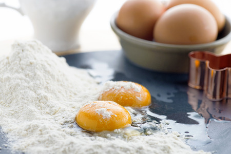 food background of eggs flour and milk, focus on the foreground , ideal for recipe which contains...