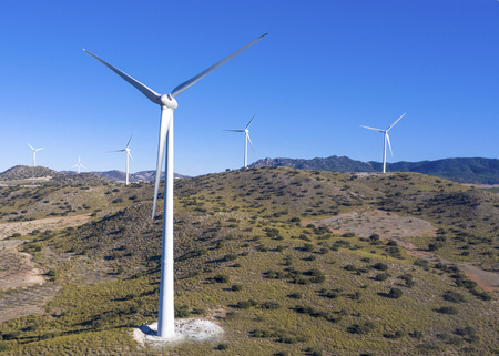 close up and high short of group of wind  turbine showing hills a blue sky background  for copy...