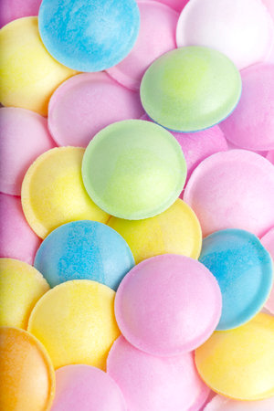 Background of flying saucer candy in pastel colours. Retro and nostalgic showcasing texture cheerful hues and a playful themeの写真素材