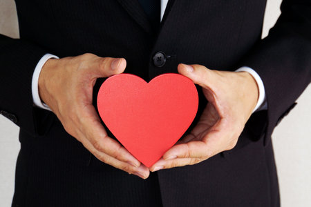 A businessman with a heart-shaped object.の写真素材