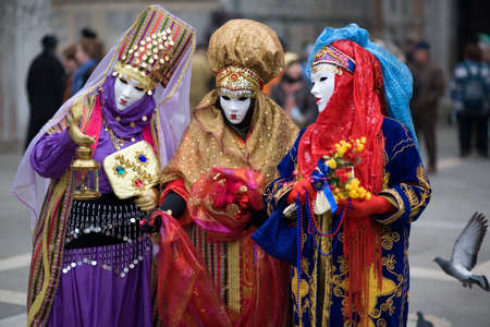 Three people are dressed for the Carnivale in Venice,Italyの写真素材