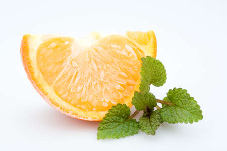 frozen orange with fresh balm, isolated on whiteの写真素材