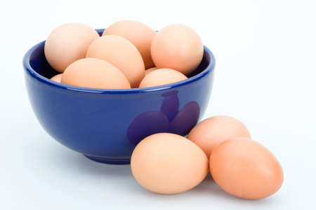 Brown eggs in the blue bowl, isolatedの写真素材