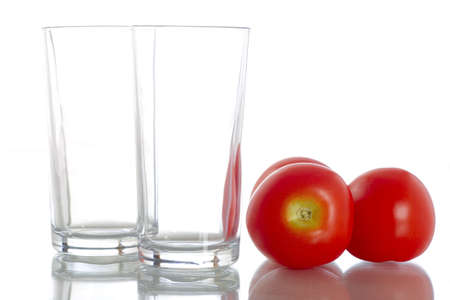 two glasses and red tomatoes, isolatedの写真素材