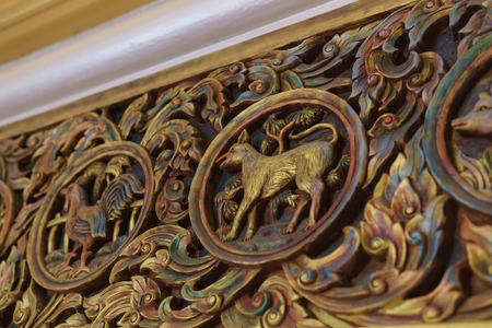 Dog Chinese zodiac carving on woodの写真素材