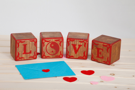 LOVE write in wooden alphabet block on bright board background. Love concept or valentine dayの写真素材