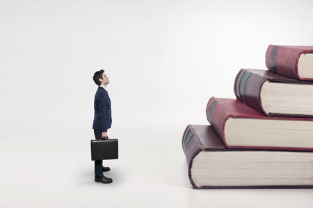 business man and stairs made of bookの写真素材