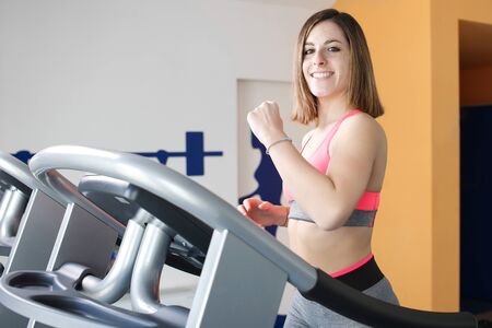 young girl doing legs exercise at gym