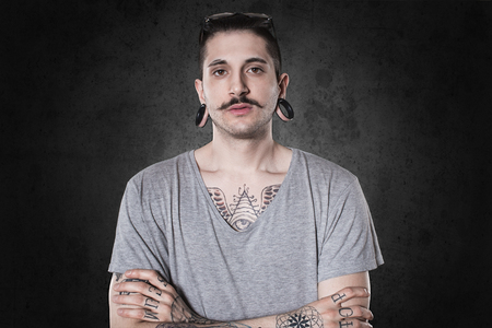 beautiful tattooed man on wall.の写真素材