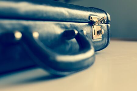 closeup of an old brown shabby brief case being opened .の写真素材