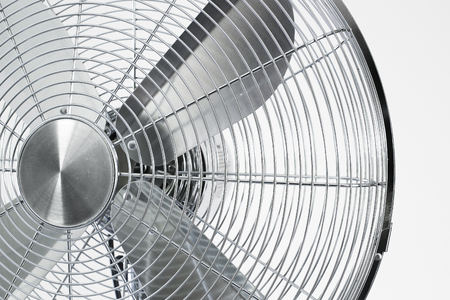 air cooler chrome Metal fan on a white background with spinning blades during summer period.の写真素材
