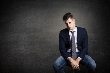 bored worker on little chairの写真素材