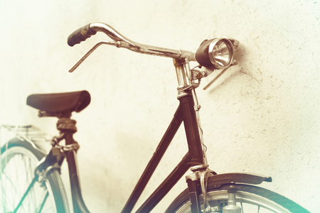 beautiful Old rusty bicycle retro with awesome effect colors on grunge grey background outodoors.の写真素材