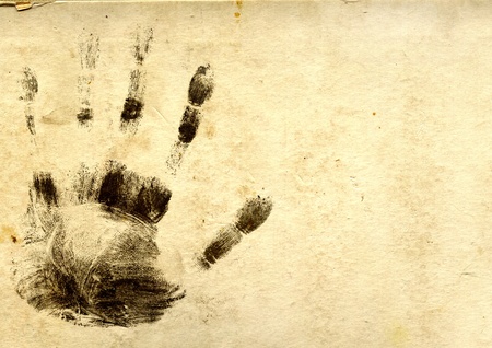 Black silhouettes of prints of fingers on paper textureの写真素材