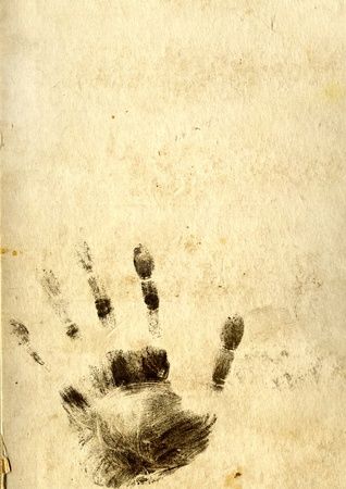 Black silhouettes of prints of fingers on paper textureの写真素材