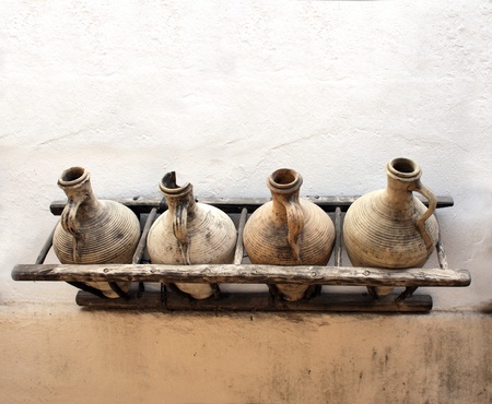 Ancient pitchers on stucco wallの写真素材