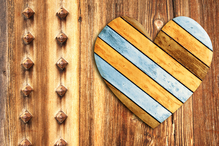 Wooden heart on old wood boardsの写真素材