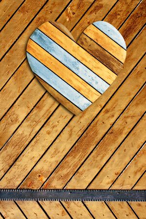 Wooden heart on old wood boardsの写真素材