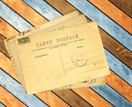 Vintage post cards on ancient wooden planksの写真素材