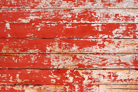 Texture of ancient wood with cracked paint of red colorの写真素材
