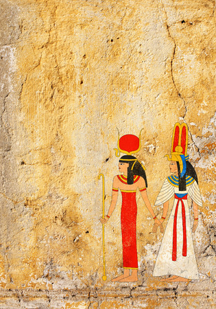 Grunge background with old stucco texture of yellow color and Egyptian goddess Isis image の写真素材