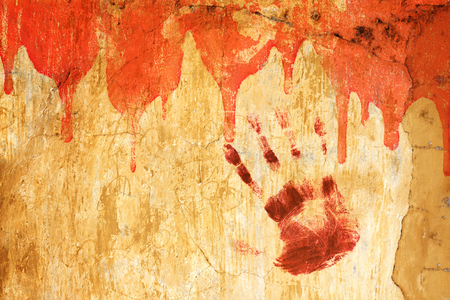 Halloween background. Blood and human palm print on stucco wall. Copy space for your textの写真素材