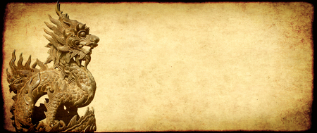 Grunge background with old paper texture and vietnamese dragon statueの写真素材