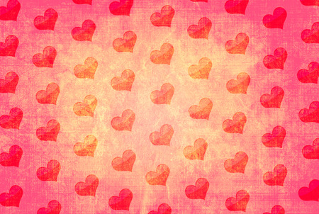 Decorative grunge valentine background with paper texture of red color and pattern with heartsの写真素材