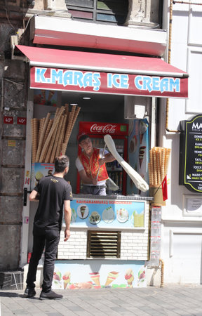 ISTANBUL, TURKEY - JUNE 7, 2019: Turkish ice cream vendor demonstrates the sticky chewy Turkish ice cream dondurmaのeditorial素材