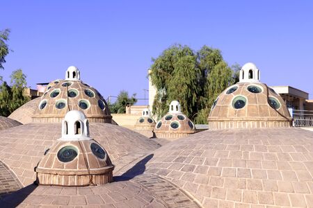 Roof of traditional iranian Sultan Amir Ahmad bathhouse with domes with convex green glasses,...