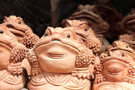 Traditional cambodian handmade souvenirs - wooden toads. Wooden frog figurine - asian mascot for good luck and wealthの写真素材